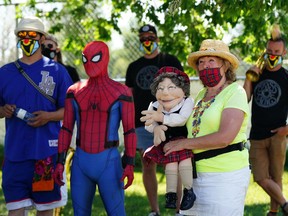 Street performers prepare for the Edmonton International Street Performers Festival community parade held in the southwest Edmonton community of Lansdowne on Saturday June 26, 2021.