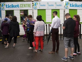 Edmontonians lineup for Taste of Edmonton food tickets, as they'll be doing this year in Churchill Square.