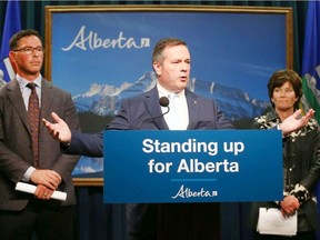 Alberta Premier Jason Kenney (C) is joined by MInister of Justice and Solicitor General Doug Schweitzer (L) and Minister of Energy Sonya Savage in Calgary to Kenney announce the launch of a public inquiry into the foreign funding of anti-Alberta energy campaigns.