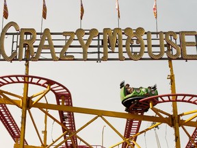 Riders take in the Crazy Mouse on the K-Days midway in Edmonton, on July 23, 2019.