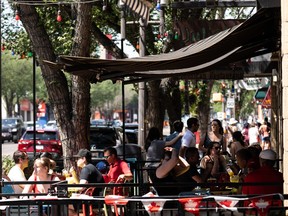 Edmontonians pack Whyte Avenue after the lifting of COVID-19 restrictions on Whyte Avenue as the temperature tops 36 degrees Celcius in Edmonton, on Thursday, July 1, 2021.