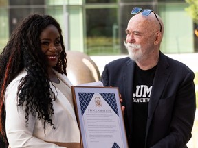 Tanika Burlie, a granddaughter of Mary Burlie receives a proclamation for Mary Burlie Day from Coun. Scott McKeen during Boyle Street Community Services’ and MacEwan University’s event held to recognize the life and legacy of Mary Burlie, an activist and advocate, at MacEwan University in Edmonton, on Tuesday, July 13, 2021. Mary was known as the “Black Angel of Boyle Street”. Photo by Ian Kucerak