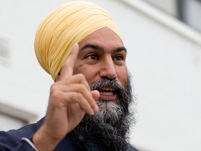 Federal NDP Leader Jagmeet Singh speaks with the media and greets supporters outside the Edmonton Downtown Farmers Market, Sunday July 18, 2021.