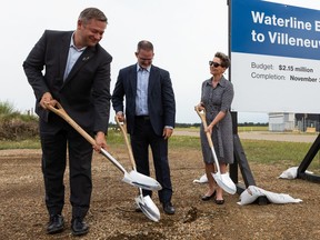 Lac Ste. Anne-Parkland MLA Shane Getson, left, Steve Maybee, vice president, operations & infrastructure with Edmonton Regional Airports Authority, and Sturgeon County Mayor Alanna Hnatiw, break ground during the announcement of a waterline extension project from the hamlet of Villeneuve to Villeneuve Airport, Thursday, July 22, 2021.