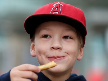 Max Gunderson, 10, enjoys pretzel bites from the German Canadian Cultural Association booth, during the opening day of Taste of Edmonton, in Sir Winston Churchill Square Thursday July 22, 2021. Taste of Edmonton runs from July 22 to August 1. Photo by David Bloom