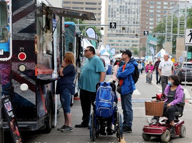 Edmontonians line up outside the Winston's Fish & Chips food truck during the opening day of Taste of Edmonton, Sir Winston Churchill Square Thursday July 22, 2021. Taste of Edmonton runs from July 22 to August 1. Photo by David Bloom