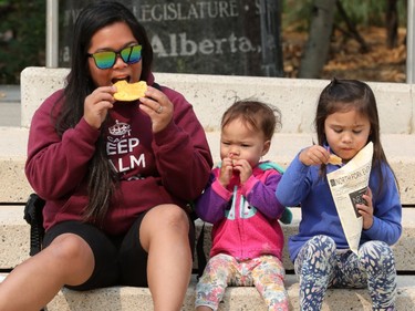Aiana Burr and her daughters Avy Burr, 1, and Ellaney Burr, 4, enjoy the opening day of Taste of Edmonton, in Sir Winston Churchill Square Thursday July 22, 2021. Taste of Edmonton runs from July 22 to August 1. Photo by David Bloom