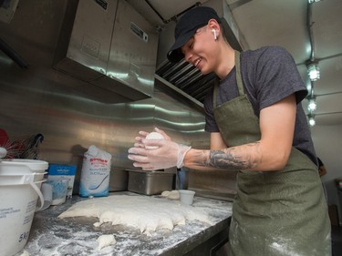 Twana Papin makes bannock, for bacon cheddar bannock sliders, at the Native Delights food truck, during the opening day of Taste of Edmonton, in Sir Winston Churchill Square Thursday July 22, 2021. Taste of Edmonton runs from July 22 to August 1. Photo by David Bloom