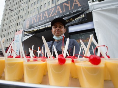 Bikram Bhandari poses with a tray of mango lassi at the Khazana booth during the opening day of Taste of Edmonton, in Sir Winston Churchill Square Thursday July 22, 2021. Taste of Edmonton runs from July 22 to August 1. Photo by David Bloom