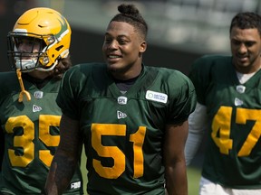 Linebackers Nyles Morgan (51), Maxime Rouyer (35) and Brandon Pittman (47) exit the field following Edmonton Elks training camp at Commonwealth Stadium on July 27, 2021.