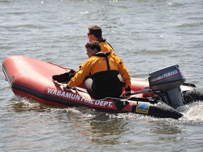 RCMP and Parkland County Fire Services search Wabamun Lake after a man went missing while tubing behind a power boat on May 26, 2012
