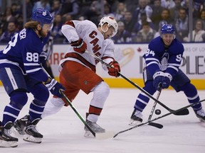 Carolina Hurricanes forward Warren Foegele (13) shoots the puck as Toronto Maple Leafs forward William Nylander (88) and defenseman Tyson Barrie (94) defend during the second period at Scotiabank Arena on Feb 22, 2020.