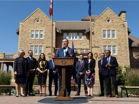 Premier Jason Kenney speaks alongside new cabinet members after a swearing-in ceremony at Government House in Edmonton on Thursday, July 8, 2021. Government ministers and associate ministers were sworn in as part of a cabinet shuffle.