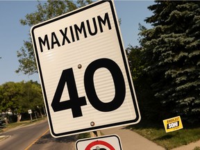 An Amarjeet Sohi sign is seen next to a 40 km/h speed sign in the King Edward Park neighbourhood of Edmonton, on Wednesday, July 14, 2021. The reduction of speed in residential neighbourhoods has become an election issue. In King Edward Park the speed was reduced to 40 due to a pilot project dating from 2010. Photo by Ian Kucerak