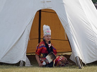 Jayme Poitras rests in the shade of a teepee at the Edmonton Heritage Festival Indigenous pavilion held in Hawrelak Park on Saturday July 31, 2021.