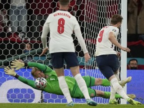 England's forward Harry Kane (R) shoots and scores off a penalty kick rebound past Denmark's goalkeeper Kasper Schmeichel during the UEFA EURO 2020 semifinal at Wembley Stadium in London on July 7, 2021.