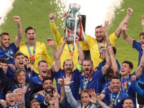 Italy's players celebrate with the European Championship trophy after Italy won the UEFA EURO 2020 final football match between Italy and England at the Wembley Stadium in London on July 11, 2021.
