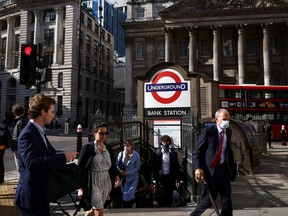 People exit Bank underground station during morning rush hour, amid the COVID-19 pandemic in London, July 29, 2021.