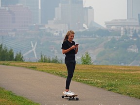 A girl skateboards on Strathearn Crescent in Edmonton on Monday July 19, 2021. The air quality health index in the city was rated high risk and residents were advised to take precautions and stay indoors if possible. The smoke in the region was caused by wildfires in neighbouring provinces.