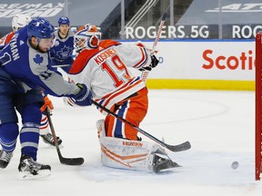 Toronto Maple Leafs forward Zach Hyman (11) scores a second period goal against Edmonton Oilers goaltender Mikko Koskinen (19) at Rogers Place on Jan 30, 2021.