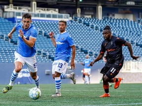 FC Edmonton striker Amer Didic (55) chases the loose ball as Christopher Nanco (11) of Forge FC defends at Investors Group Field in Winnipeg on July 1, 2021.