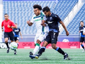 Cedric Toussaint of York United FC, left, and Shamit Shome of FC Edmonton battle for the ball in a Canadian Premier League match at Investors Group Field on July 24, 2021.