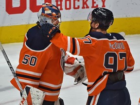 Edmonton Oilers captain Connor McDavid (97) congratulates goalie Stuart Skinner (50) after defeating the Ottawa Senators 8-5 at Rogers Place in Edmonton on Jan. 31, 2021.