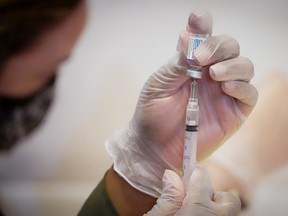 A health-care worker prepares a dose of the Johnson & Johnson vaccine for COVID-19 during the opening of the MTA's public vaccination program at Grand Central Terminal train station in Manhattan in New York City, May 12, 2021.