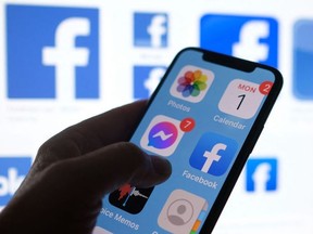 This file photo illustration photo shows a Facebook App logo displayed on a smartphone in Los Angeles, March 1, 2021.