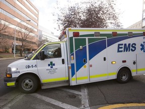 An Alberta Health Services ambulance is seen leaving the the Royal Alexandria Hospital in Edmonton, Alta., on Thursday, Oct. 16, 2014. AHS and the province announced a pilot project involving two new Rapid Transfer Units at the Royal Alexandria Hospital and the University of Alberta Hospital. The units are intended to improve patient flow at emergency rooms and reduce the amount of time EMS crews spend waiting in hospitals. Ian Kucerak/Edmonton Sun/ QMI Agency