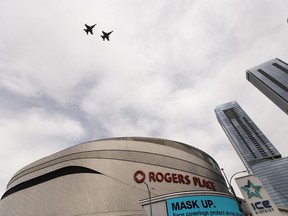 Two  CF-18 fighter jets fly over Rogers Place for Game 4 of the Stanley Cup final between Dallas Stars and Tampa Bay Lightning on Friday, Sept. 25, 2020 in Edmonton.