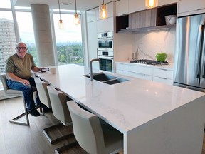 Michael Reynolds enjoys the eighth-storey view from the kitchen of his West Block Glenora home.