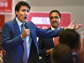 Prime Minister Justin Trudeau delivers remarks to volunteers and supporters in Minister of Natural Resources Amarjeet Sohi's (R) riding in Edmonton Mill Woods, July 11, 2019.