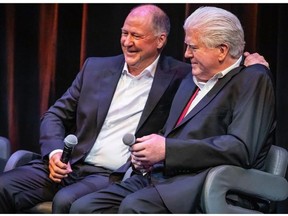 Kevin Lowe, left, shares the stage with former rival general manager Brian Burke at a fundraiser last week to help cancer research.