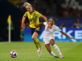Fridolina Rolfo of Sweden is challenged by Ashley Lawrence of Canada during the 2019 FIFA Women's World Cup France Round Of 16 match between Sweden and Canada at Parc des Princes on June 24, 2019 in Paris, France.