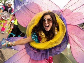 Dancers with the Caribbean Women’s Network lead the Cariwest Carnival Parade through the Ambleside neighbourhood of Edmonton, on Saturday, Aug. 7, 2021. Spectators were encouraged to bring a lawn chair to catch the parade which would through their neighbourhood and through Ambleside Park.