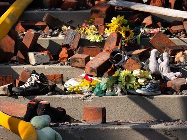 Fallen bricks and childrens’ shoes and toys are seen on the steps of St. Jean Baptiste Church in Morinville, north of Edmonton, on Wednesday, Aug. 25, 2021. The church burned down on June 30 and the fire is under investigation. Photo by Ian Kucerak