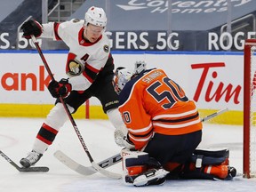 Edmonton Oilers goaltender Stuart Skinner (50) makes a save against Ottawa Senators forward Brady Tkachuk (7) during the second period at Rogers Place.