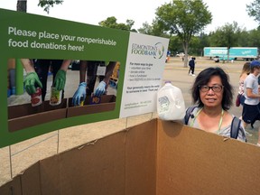 Edmonton Food Bank volunteer Grace Dai was collecting food and cash donations during the Edmonton Heritage Festival in Hawrelak Park on Sunday August 1, 2021.