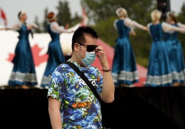 A festival goer follows pandemic protocols during the Edmonton Heritage Festival in Hawrelak Park on Sunday August 1, 2021.