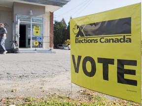 A man leaves a polling station after casting his ballot on federal election day in Shawinigan, Que., Oct. 21, 2019.