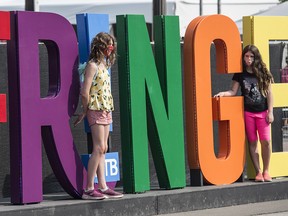 The giant colourful letter on 83 Ave. draw a crowd for  photos at the Edmonton Fringe Festival in Old Strathcona.on August 15, 2021. Photo by Shaughn Butts / Postmedia