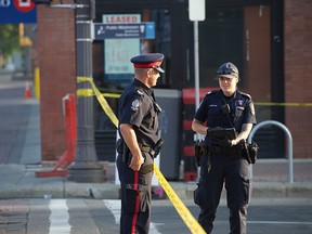 Police investigate at Whyte Avenue between 103 and 104 Streets last week. One man has since been charged with second-degree murder.