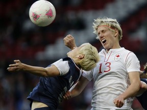 United States' Megan Rapinoe (left) heads the ball against Canada's Sophie Schmidt during their semifinal women's soccer match at the 2012 London Summer Olympics. Canada lost a controversial 4-3 decision but rallied to claim the bronze medal.