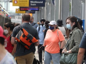 City transit users are seen wearing masks on an LRT platform downtown. Tuesday, Aug. 3, 2021.