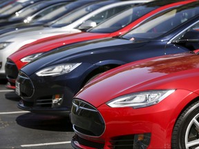 A row of Tesla Model S sedans are seen outside the company's headquarters in Palo Alto, Calif., April 30, 2015.