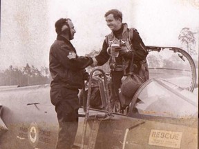 A ground crew member presents pilot Laurie Hawn with a beer after he piloted the last CF-104 Starfighter flight in Germany in 1975.