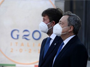 Italy Prime Minister Mario Draghi (R) and Cuture minister Dario Franceschini arrive to the Colosseum on the first day of the G20 Culture Ministers meeting on July 29, 2021 in Rome. (Photo by Filippo MONTEFORTE / AFP)