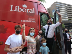 Prime Minister Justin Trudeau (R), his wife Sophie Gregoire Trudeau and their children Xavier (L-R), Ella-Grace and Hadrien wave to supporters while boarding his campaign bus on August 15, 2021 in Ottawa.