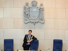 Mayor Don Iveson poses under the City of Edmonton coat of arms. File photo.
